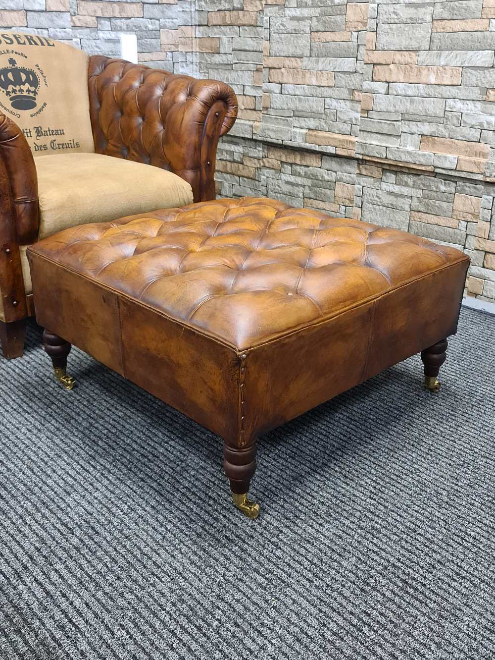 Austin LEATHER OTTOMAN WITH BRASS WHEELS